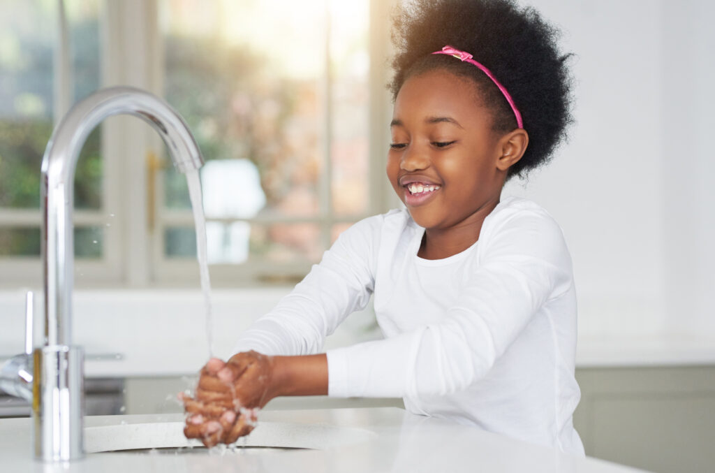 Little girl washing hands, an essential self-help skill